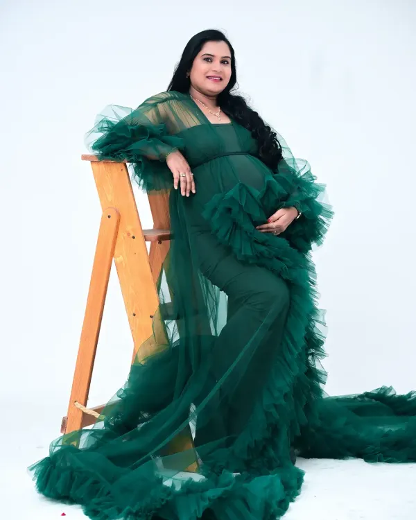 This stunning emerald green tulle gown is a favorite in my collection. The ruffled fabric creates incredible texture and drama, and the color is rich and vibrant. It's perfect for a glamorous and memorable portrait.