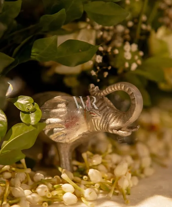 It's the smallest details that whisper the loudest. I tucked this miniature silver elephant amidst a bed of fragrant mogra, a small symbol of good fortune and a delightful surprise for observant guests.