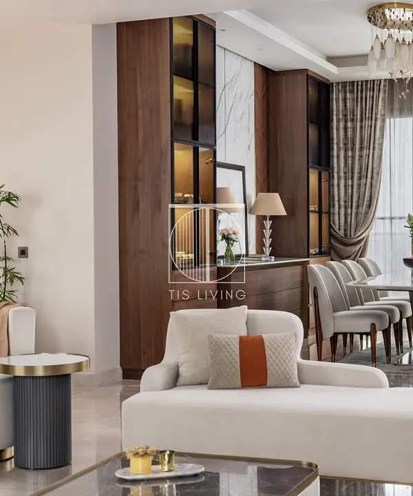 A complete living and dining space where we fabricated all the loose furniture. Notice the curved lines of the white sofa, the custom upholstery on the dining chairs, and the precisely crafted dining and storage units, all working together to create a cohesive, modern luxury environment.