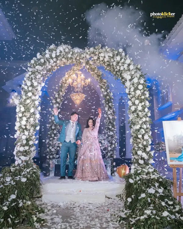 A fairytale entrance for the happy couple under a magnificent floral arch, showered with confetti. We specialize in capturing these grand, unforgettable moments that define your celebration.