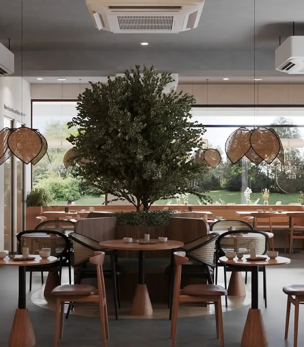 The main dining area is defined by a large, beautiful tree that brings life and tranquility to the space. We used a mix of chair styles, including rattan and wood, to add visual interest while maintaining a cohesive, nature-inspired theme.