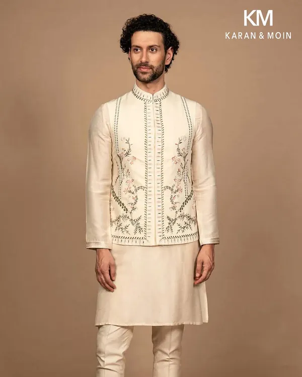 A full view of the ivory kurta set with its intricately embroidered Nehru jacket. The complete look is one of timeless minimalism, where every detail is intentional and every thread reflects purposeful design.