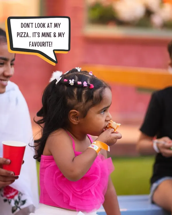 A little guest enjoying her favorite slice of pizza. Our party food is always a hit with the kids.
