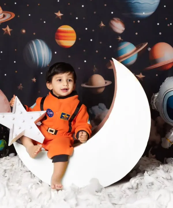 We love bringing big imaginations to life, like this little astronaut's first mission to the moon. Our themed photoshoots include detailed backdrops and costumes to create a magical world for your child.