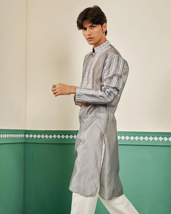 The pearl grey Chanderi silk kurta in motion, showing its elegant drape and the intricate white embroidery on the sleeves.