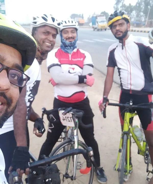 A selfie with the crew during a century ride. Everyone is geared up in full cycling kit, ready to take on the highway.