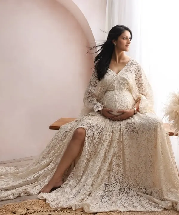 This is the essence of the motherhood glow I love to capture. In the quiet comfort of my studio, we used soft, natural light and a beautiful lace gown to create this timeless and serene portrait.