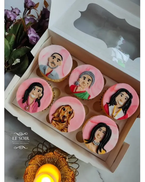 These custom cupcakes were so special to make. I hand-painted fondant portraits of an entire family, including their adorable golden retriever, to celebrate a special occasion. This is the kind of personal, edible art I love creating.