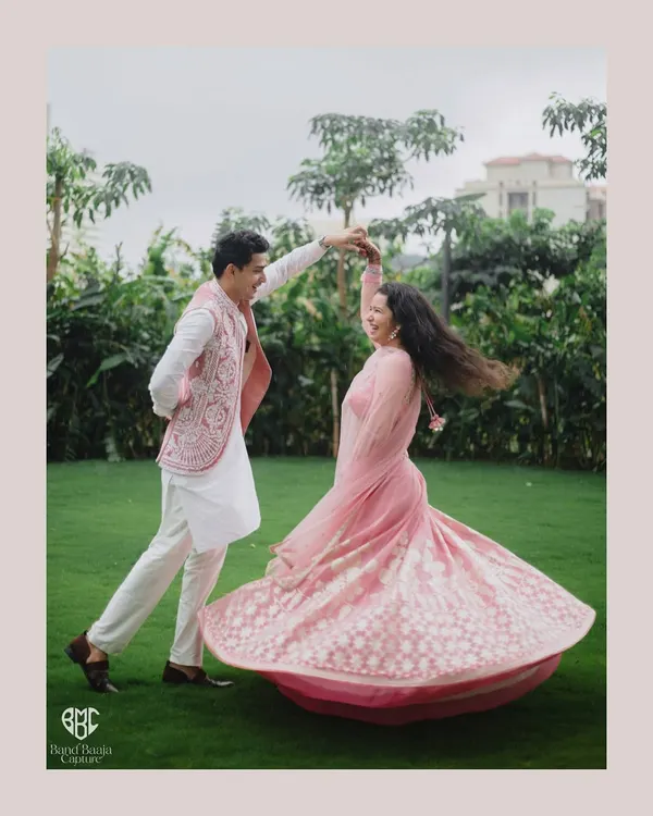 A dance of pure happiness. We love creating these dynamic, joyful portraits that capture the couple's vibrant energy and love for each other in a beautiful outdoor setting.
