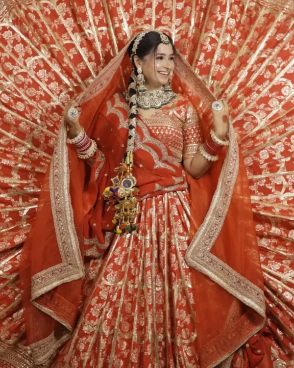 This is the dream bridal lehenga for your big day. The classic red color, intricate gold work, and the grand flare of the skirt make for unforgettable wedding photos.