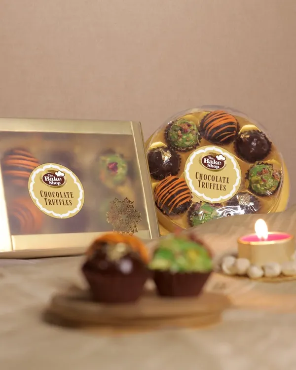 Our chocolate truffles are available in beautifully designed round and rectangular gift boxes. This image showcases our elegant packaging, making it an ideal gift for any celebration.