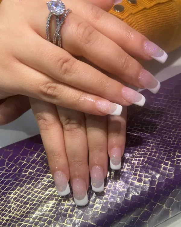 The perfect classic French manicure. This set features a soft pink base with crisp white tips on a medium-length square nail.