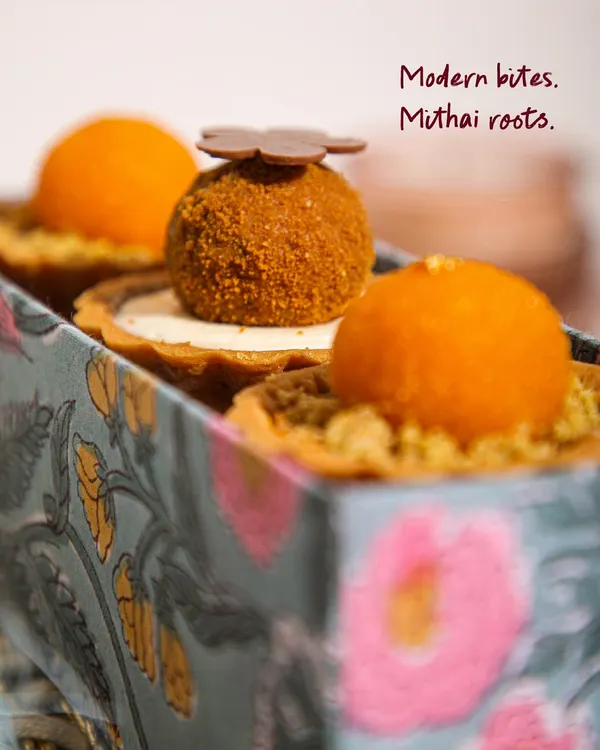 Modern bites with mithai roots. This close-up shows the beautiful texture and detail of our signature Mithai Tartlets, a fusion of Indian sweets and French pastry.