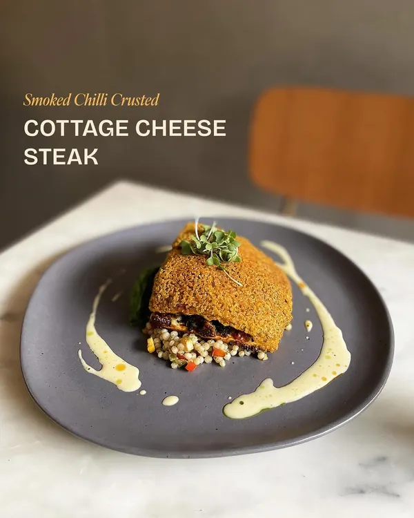 Back on the menu by popular demand. This is our Smoked Chili-Crusted Cottage Cheese Steak, stuffed with olives and sun-dried tomatoes, served on Israeli couscous with a jalapeño cheese fondue.