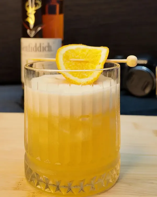 A classic Whisky Sour, perfectly balanced with a frothy top. This cocktail is a staple on my menu, made with your choice of whisky, fresh lemon juice, and a touch of sweetness.