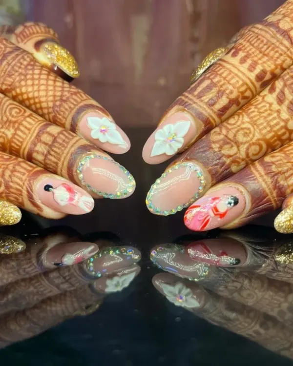 The ultimate bridal manicure. This set, shown against beautiful henna, features incredibly detailed hand-painted art, 3D flowers, and glitter, creating a truly one-of-a-kind look for a bride's special day.