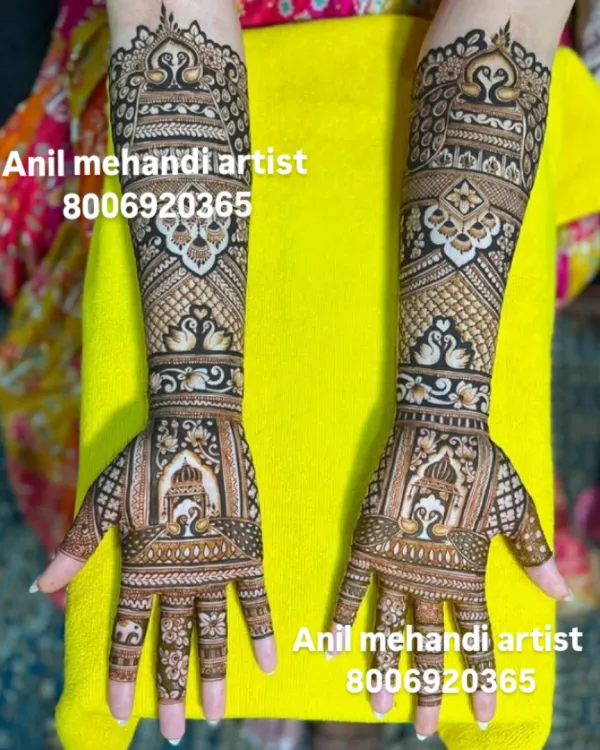 A beautiful and symmetrical design featuring palace windows (jharokhas) and peacock motifs. The fine line work and dense patterns are perfect for a full bridal look.