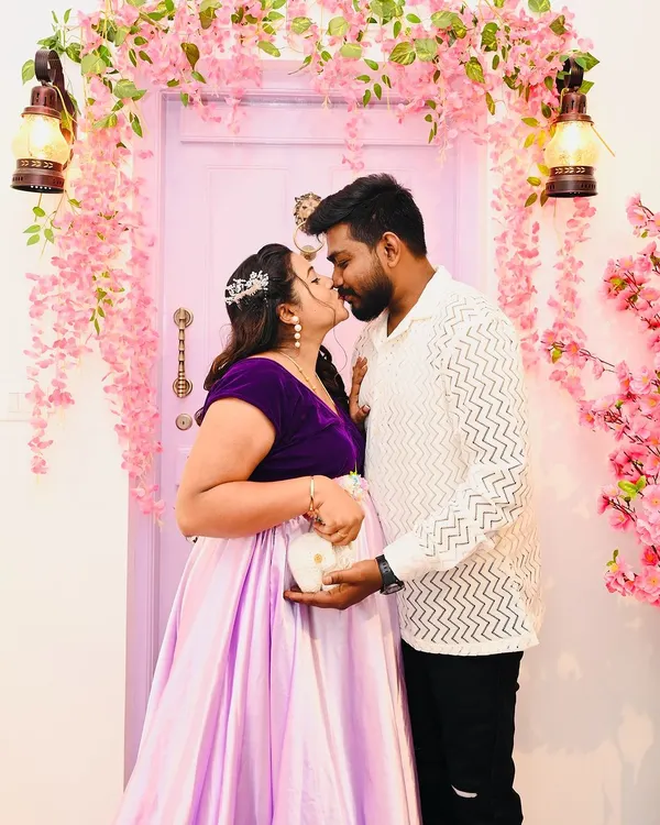 A classic pose in front of the blossom door, this shot highlights the joy of expecting. The couple holds baby shoes, a simple prop I provide to add a sweet touch to your maternity announcement.
