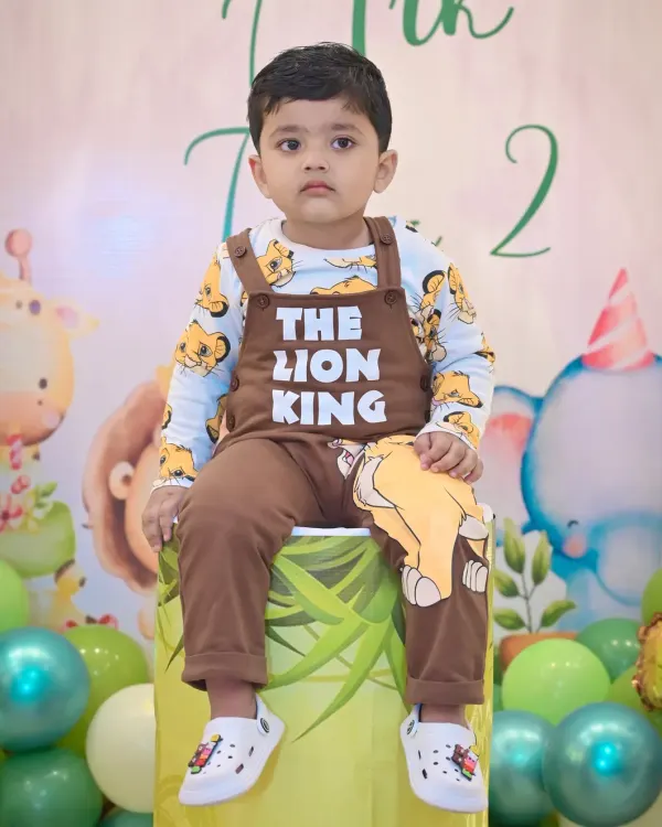 A handsome little boy in his 'The Lion King' themed outfit for his second birthday shoot.