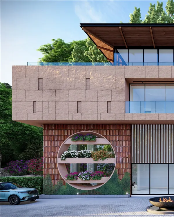 The facade of our biophilic residence in Dehradun, featuring a large circular cutout with integrated planters. This design element acts as a living green wall, seamlessly blending the architecture with the natural, forested landscape.