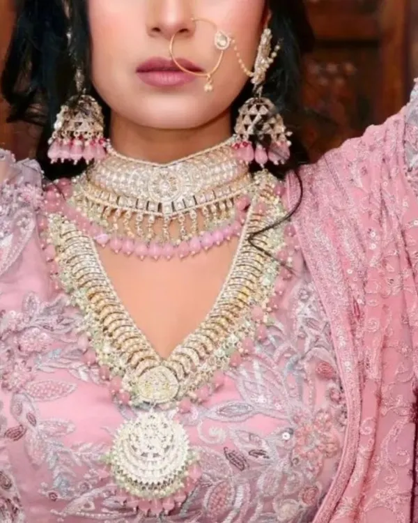This pastel pink lehenga with intricate silver embroidery is a popular choice for engagement ceremonies. It's paired here with a matching pink-beaded choker and rani haar set.
