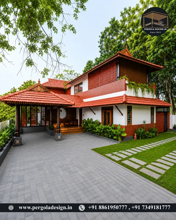 A beautiful Kerala-style home featuring an extended porch with a traditional tiled roof. This structure provides a shaded, welcoming entrance that perfectly matches the home's architectural heritage.