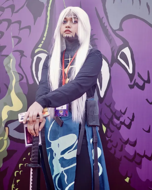 A cosplayer poses in front of a vibrant, custom backdrop at Comic Con India. I make sure to use the event's unique environment to create memorable photos.