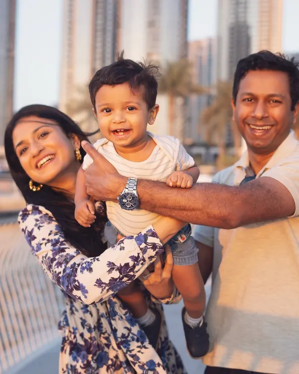A candid family moment during a golden hour shoot in Dubai. The warm light and genuine smiles create a perfect, happy memory.