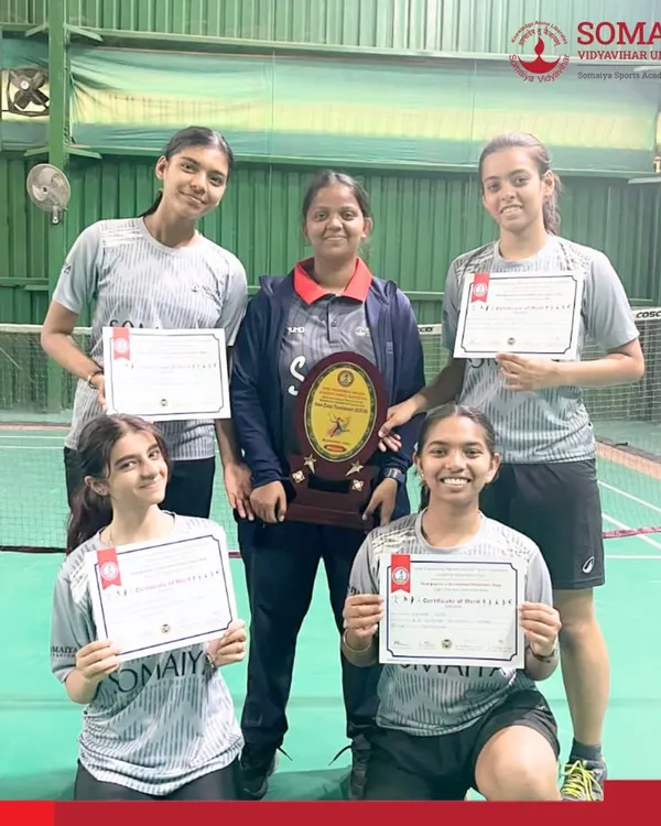 The K. J. Somaiya Polytechnic Women’s Badminton Team celebrates with their trophy and certificates after becoming champions of the Inter-Zonal State Level Tournament.
