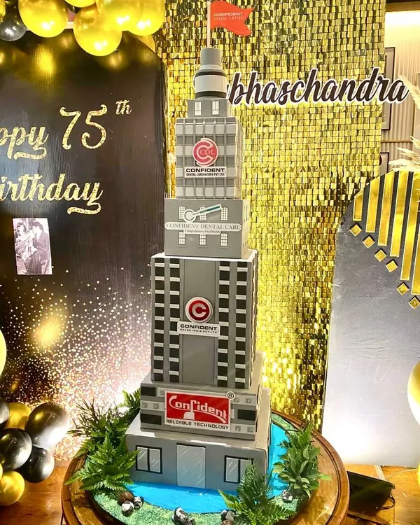 We were commissioned to create this massive building cake for a 75th birthday celebration. Standing over 4 feet tall, it's a replica of the company's buildings, complete with a lake and greenery at the base.