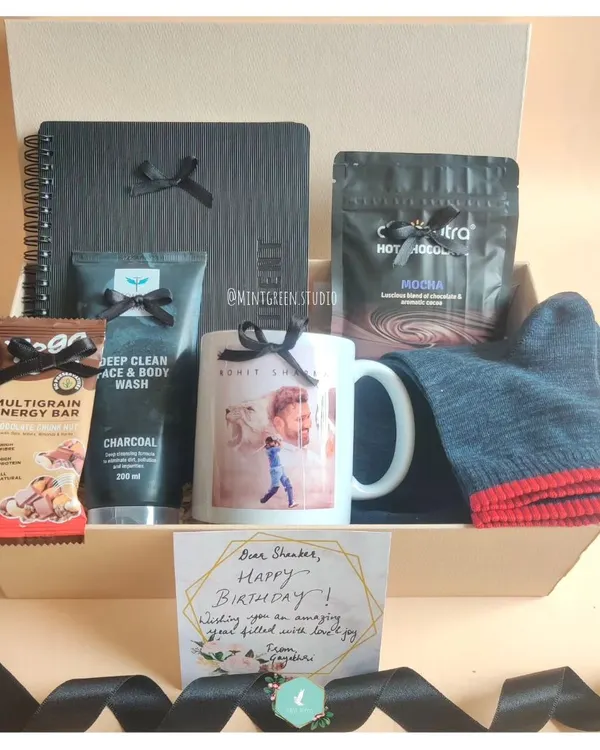 A birthday hamper designed for a cricket fan. It includes a personalized mug with his favorite player, charcoal face wash, hot cocoa, and other treats to make his day special.