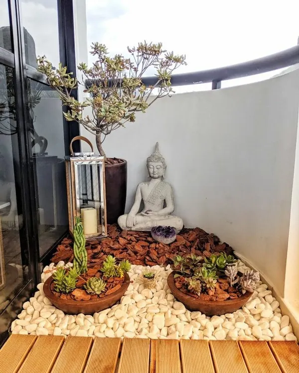 I believe every corner holds potential for peace. Here, I transformed a small balcony space into a personal zen garden, using a meditating Buddha statue, low-maintenance succulents in shallow bowls, and a mix of natural wood chips and smooth white pebbles to create a tranquil retreat.