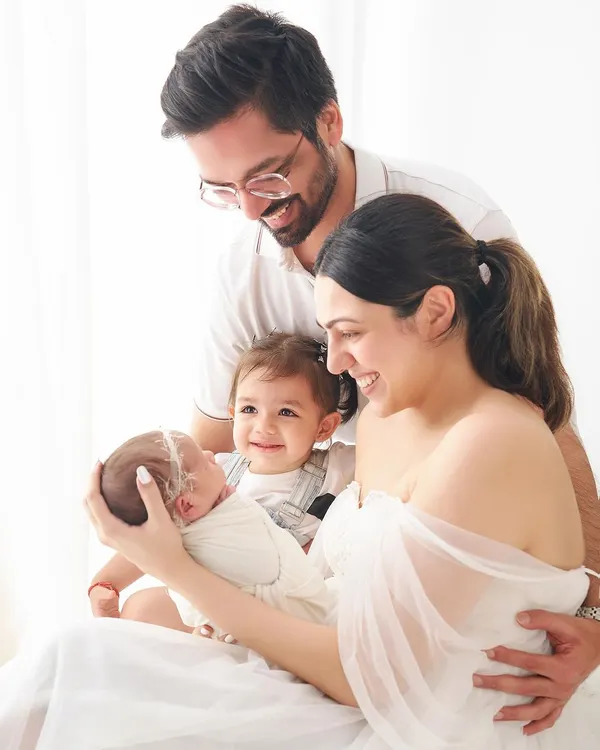 This is what it's all about: capturing the pure, unscripted joy of a family welcoming their newest member. We styled this session with clean, white outfits to keep the focus on the beautiful bond between the parents, their toddler, and the sleeping newborn.