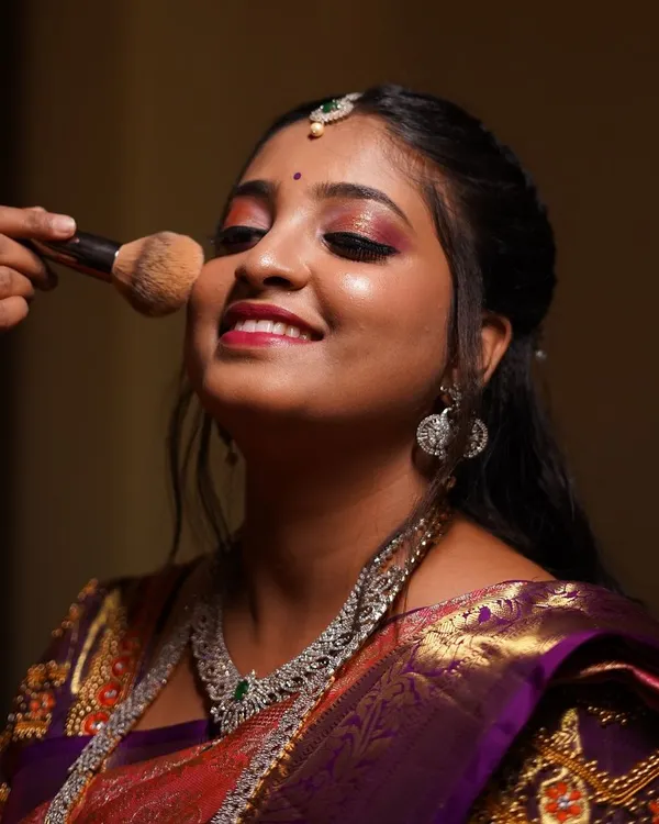 The getting-ready process should be just as joyful as the main event. Here I am adding the finishing touches, ensuring my bride feels relaxed, happy, and confident. It’s all about creating that perfect, stress-free vibe.