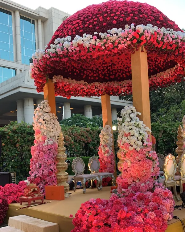 A true pink paradise for a union of hearts. This magnificent dome mandap is covered in thousands of ombre pink and white roses, creating an enchanting and regal space for the wedding ceremony at the Taj Santacruz.