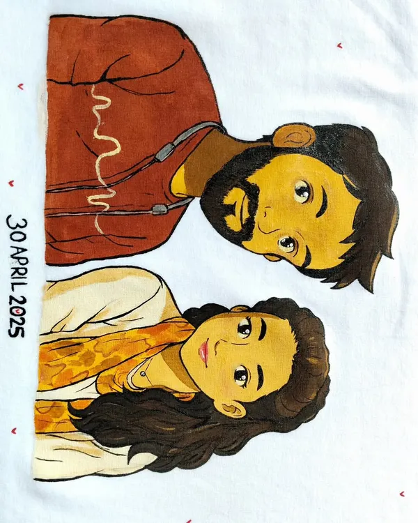 A close-up of the hand-painted couple portrait on a t-shirt. I use high-quality fabric paints to ensure the artwork is durable and the colors stay vibrant even after washing. The date marks a special anniversary.