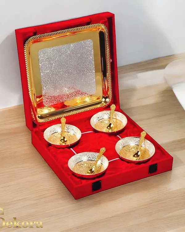 This silver and gold plated bowl set is one of our most popular choices for festive corporate gifting. It comes in a luxurious red velvet box containing four intricately designed bowls with matching spoons and a serving tray, ready to be presented as an elegant Diwali or wedding gift.