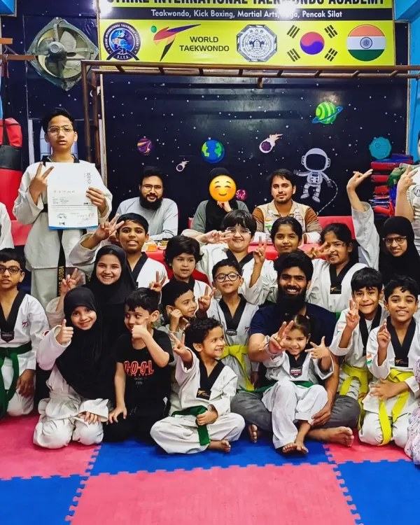 A happy group photo of my students after a successful belt promotion test at the academy. Everyone is proud of their new ranks.