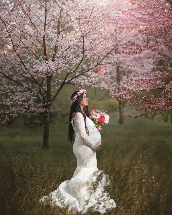 A truly magical moment for this mom-to-be, standing in a beautiful grove of pink cherry blossoms. This ethereal pregnancy portrait captures the wonder and beauty of awaiting a new life.