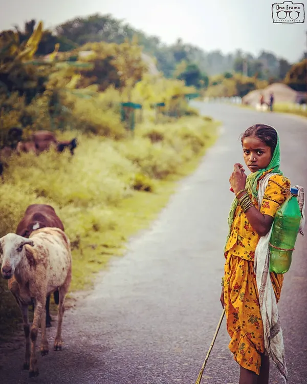 This portrait of a young girl in Hampi is one of my favorites. I used the soft, natural light and the rural road as a backdrop to frame her striking expression. This is the essence of an artistic travel portrait, capturing a powerful human moment.