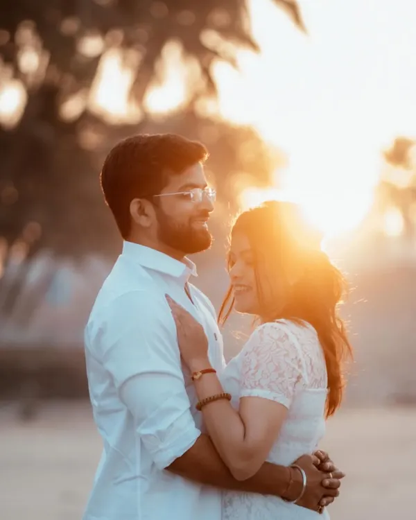 Bathed in the golden light of sunset, a couple shares a tender embrace on the beach. This is the kind of warm, sun-kissed pre-wedding photography I specialize in.