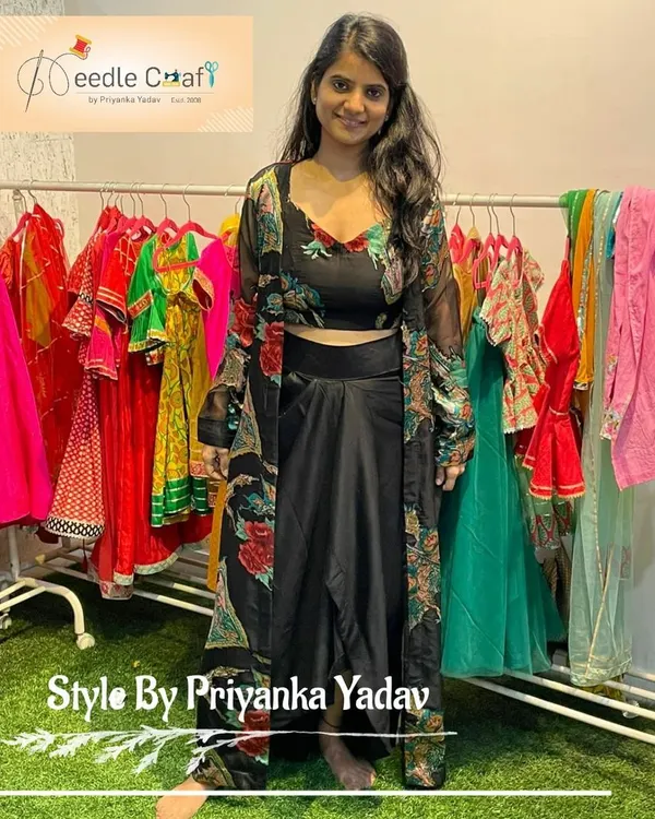 This Indo-Western three-piece set was made from an old saree. It includes a crop top, a stylish drape skirt, and a matching longline sheer jacket.