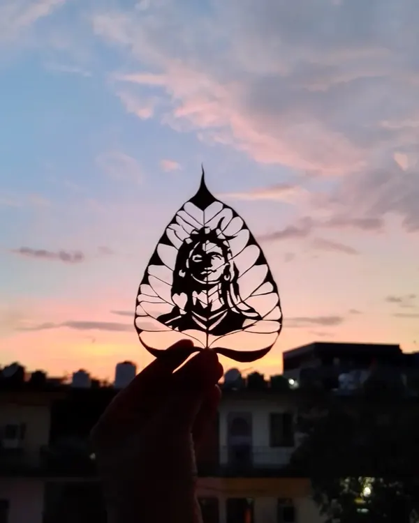 This carving of Adi Yogi is a piece I am very proud of. The natural veins of the Peepal leaf complement the design, and holding it against the sky creates a powerful, meditative image.