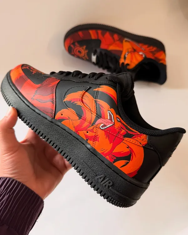 A close-up of the Kurama Nine-Tails custom Nike Air Force 1s. This angle shows the flaming tails wrapping around the side of the shoe, creating a sense of dynamic motion.