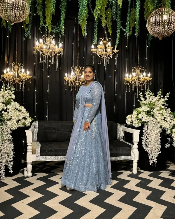 Ready for the sangeet night! This stunning powder blue lehenga, fully adorned with sequins, is designed to catch the light as you dance the night away.