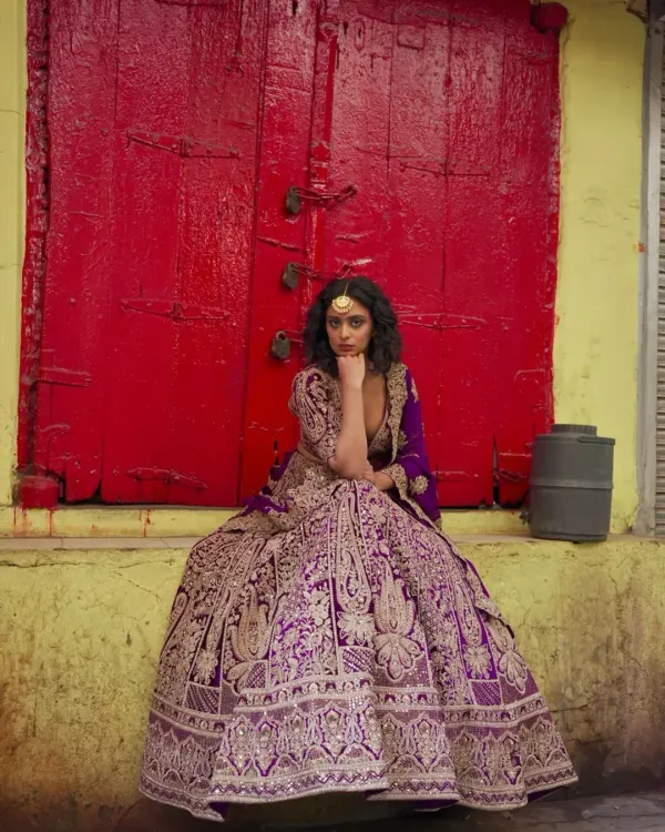 This is for the bride who dreams of a royal wedding. A magnificent purple lehenga with incredibly detailed gold embroidery, designed to make you feel like you’ve stepped out of a palace.