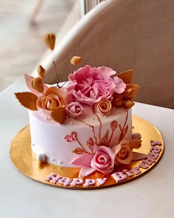 This elegant birthday cake with handcrafted sugar flowers is a great example of my custom design work. I can create personalized cakes for any theme or style.