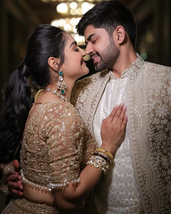 A coordinated couple look is more than just matching colors. It's about complementary textures and embroidery, like his subtly detailed coat next to my shimmering lehenga, creating a harmonious picture.