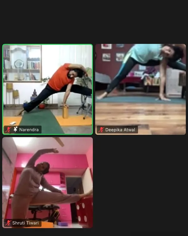 A screenshot from my online yoga class, showing students in various poses. I use props like blocks and chairs even in online sessions to ensure proper alignment.