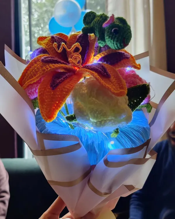This custom Tangled-themed bouquet is a perfect example of how we can bring your favorite stories to life. It features Sundrop flowers, chamomile, and roses, all wrapped up with twinkling fairy lights for a truly magical gift.
